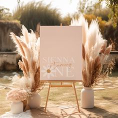 an easel with flowers and pamodia in front of it on the ground