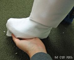 a person wearing white socks and holding something in their hand