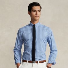 This striped shirt is crafted with breathable lightweight cotton and features a tab collar that highlights a tie knot by raising it up. At the right hem the iconic Polo Pony adds a signature touch. Pinstripe Dress Shirt With Striped Collar In Cotton, Pinstripe Dress Shirt With Striped Collar, Pinstripe Cotton Dress Shirt With Striped Collar, Ralph Lauren Fitted Business Top, Ralph Lauren Fitted Striped Shirt, Ralph Lauren Striped Shirt For Spring, Ralph Lauren Classic Business Shirt, Fitted Ralph Lauren Shirt For Business, Classic Ralph Lauren Dress Shirt For Business