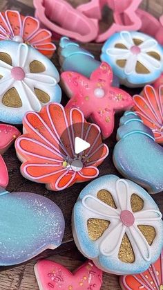 some cookies are decorated like flowers and butterflies