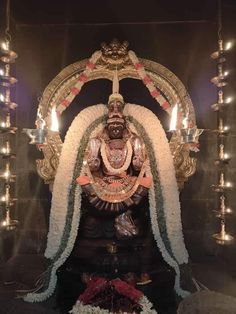 the statue is decorated with flowers and candles