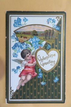 a valentine card with an angel holding a bouquet of blue flowers and the words, valentine greeting