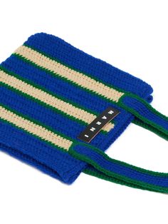 a crocheted blue and green bag with a tag on the front that says,