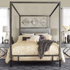 a bedroom with a four poster bed and two nightstands