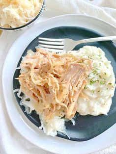 a white plate topped with meat and mashed potatoes