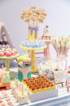 a table topped with lots of cakes and desserts