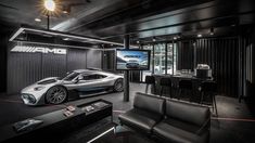 a car is parked in the middle of a room with black leather chairs and tables