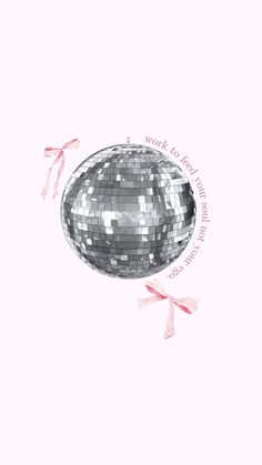 a silver disco ball with pink bows on it