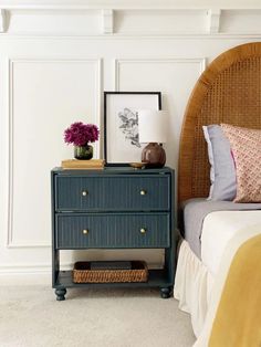 a bedroom with a wicker headboard and blue dresser