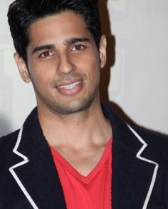 a man in a red shirt and black jacket