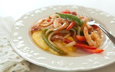 a white plate topped with shrimp and veggies