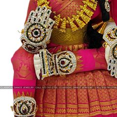 Design by Classical Dance Jewelry® ❥ Product Details: Designer Goddess Vara Lakshmi idol ❥ Material is mixed Alloys ❥ Color: Pink and Gold ❥ Beautiful saree deign Goddess Lakshmi in sitting posture ❥ Beautifully decorated mask used for pooja during Varalakshmi Vratham ❥ Completely Decorated with High Quality Stones and pearls Height of Ammavari Idol : 19-20 Inchs ( Large Size) Set includes ☛ Lakshmi Idol : 1 ☛ Lakshmi Mask : 1 ☛ Magalasutram : 1 ☛ Hastalu Padallu : 1 Set ☛ Short Haram : 1 ☛ Long Multicolor Lehenga For Rituals And Festive Occasions, Ceremonial Traditional Wear With Stone Work For Diwali, Multicolor Lehenga For Diwali Rituals, Multicolor Festive Lehenga For Rituals, Festive Traditional Wear With Stone Work For Festivals, Traditional Choli With Stone Work For Festivals, Traditional Drape Choli With Pallu For Rituals, Bollywood Style Choli With Pallu For Rituals, Traditional Drape Choli With Stone Work For Festivals