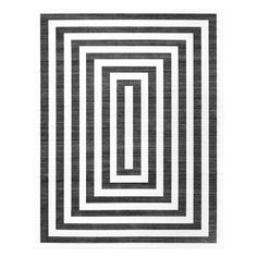 a black and white rug with an interlocked square pattern on the bottom half