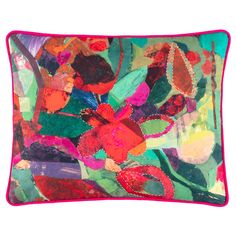 a colorful pillow with flowers and leaves on it