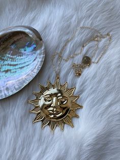 "When you need to add some intense happiness and sunshine to your day, enter the giant sun necklace. Sun is approximately 2.25\" wide, on a (short) 16\" gold-filled chain with 2\" extender. Based on a vintage design, and given a new life in New England using recycled brass and a genuine 14k gold finish. Nickel free. The Ravenstone Process: Ravenstone jewelry is made with intention. Our pieces are made from sustainable, recycled brass finished in genuine precious metals and paired with the most c Bohemian Sun-shaped Gold Jewelry, Gold Sunburst Jewelry With Sun And Moon Design, Celestial Gold Sunburst Jewelry, Gold Celestial Sunburst Jewelry, Necklace Sun, Sun Necklace, Nickel Free Jewelry, Golden Sun, Gold Filled Chain