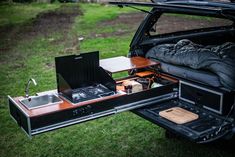 the open trunk of a car with an oven and stove in it