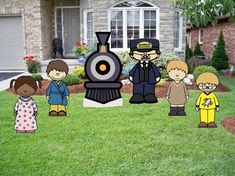 a group of people standing in front of a train on the grass near a house