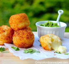 some food that is sitting on a table next to a bowl and cup with something in it