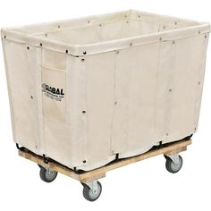 a large white box sitting on top of a wooden pallet with two wheels and a canvas cover over it