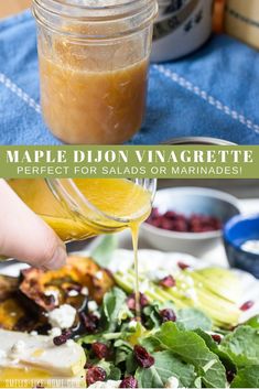 someone pouring maple dijon vinagrete into a salad