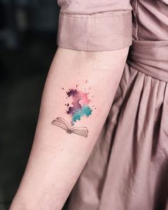 a woman with a book tattoo on her arm