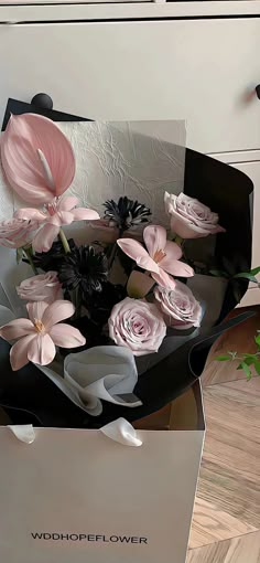 a white box with pink flowers in it