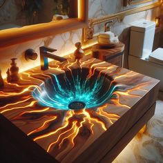 a bathroom sink with an artistic design in the center and blue light coming from it