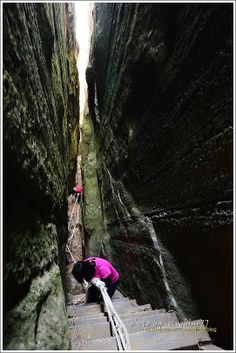 a person climbing up some stairs in a canyon