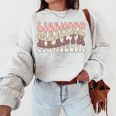 This cozy LMHC Therapist sweatshirt is a perfect fit for the therapist who loves to lounge around in it or wear around the office. This crewneck sweater has a simple, but meaningful message: "I'm a mental health therapist, and I care. You can too." Note: ♡ Our products are made to order specially for you. We have included size charts and a quick memo on finding the perfect size!  ♡ We don't accept returns or exchanges. Please check our color and size charts before you place your order :) ♡ Pleas Cotton Graphic Print Tops For Lounging, Casual Tops With Letter Print For Lounging, Relaxed Fit Graphic Print Top For Lounging, Graphic Print Crew Neck Top For Lounging, Crew Neck Top With Graphic Print For Relaxation, Graphic Print Crew Neck Tops For Relaxation, Relaxation Graphic Print Crew Neck Top, Safe Space Poster, Social Worker Appreciation