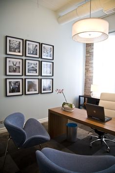 an office with chairs and pictures on the wall