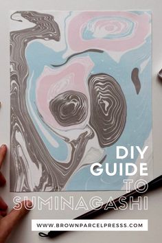 someone's hand holding a piece of art with the words diy guide to summagashi