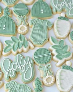 decorated cookies with green and white frosting for baby shower decorations on a table top