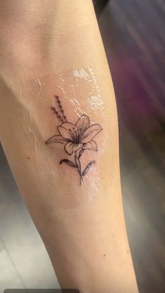 a small flower tattoo on the leg