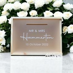 a sign that says mr and mrs hammerton on it in front of white flowers