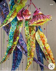 an art work with colorful flowers hanging from strings