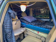 there is a bed in the back of an suv