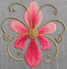 a pink and gold flower on a gray background