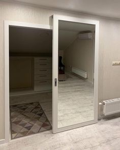 an empty room with sliding glass doors leading to the bedroom and another closet in the background