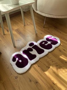 a purple and white rug with the word love on it