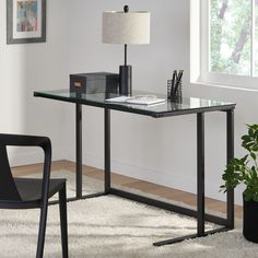 a glass desk with a lamp on top