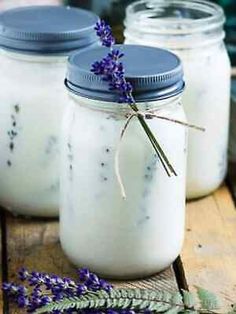 three jars filled with lavender sitting on top of a wooden table