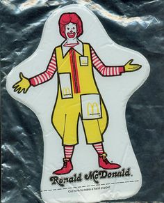 a plastic sign with a man dressed as ronald mcdonald