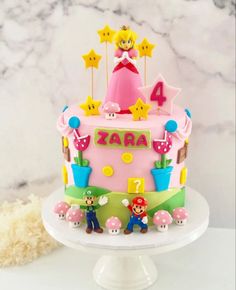 a pink birthday cake with mario and princess peaches on top, surrounded by stars