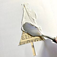 someone is cutting out a piece of paper with a large spatula and measuring tape