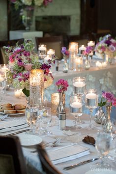 the table is set with candles and flowers