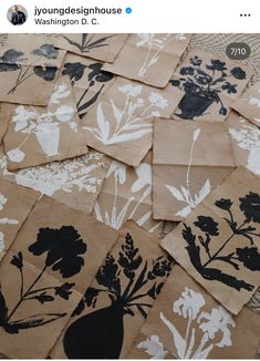 several pieces of brown paper with black and white flowers on them