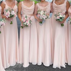 the bridesmaids are all wearing pink dresses and holding bouquets in their hands