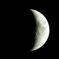 the moon is seen in the dark sky with its shadow on it's side