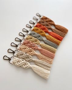 a row of different colored tassels sitting on top of a white table next to each other