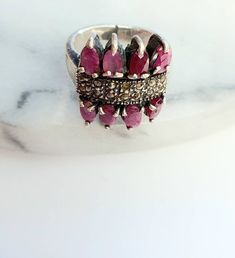 Vintage ruby ring,statement ring,gemstone ring,silver old ring,size 7US,gift for her,unique gift,ruby jewellery,red gemstone Size:7 US This handcrafted ruby vintage ring is stunning. The ring is vintage and used missing some crystals, however the main ruby stones are well secured and looks amazing. The metal for the ring is stamped 925 silver. Makes a perfect gift for a vintage jewelry lover, or a sparkle for your own collection. Elegant Cluster Ring With Stones As Gift, Fine Jewelry Ruby Ring As Gift, Fine Jewelry Ruby Gift, Ruby Rings Fine Jewelry As Gift, Ruby Rings For Gifts, Fine Jewelry Style, Engraved Ruby Ring For Gift, Fine Jewelry Ruby Ring For Jewelry Making, Vintage Round Gemstone Jewelry, Ruby Cluster Ring Gift Fine Jewelry